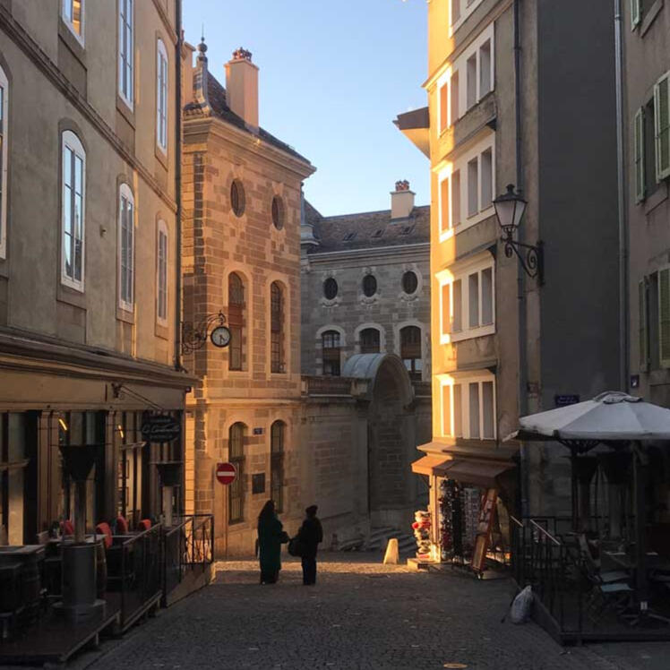 Sunset streets, Geneva - friends pause for an impromptu conversation in the winter light, reflecting the rhythm of the Old Town.